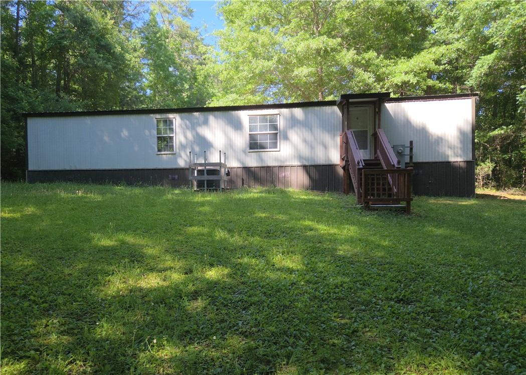 238 Forest Lane Starr, SC 29684 - Photo 10 of 11 A quaint residential structure rests amidst a verdant landscape, surrounded by towering trees.