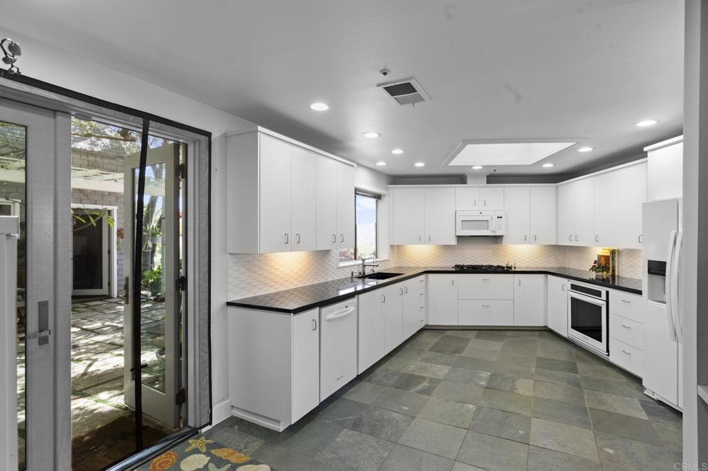 14645 High Valley Road Poway, CA 92064 - Photo 11 of 34 a large kitchen with stainless steel appliances lots of counter top space