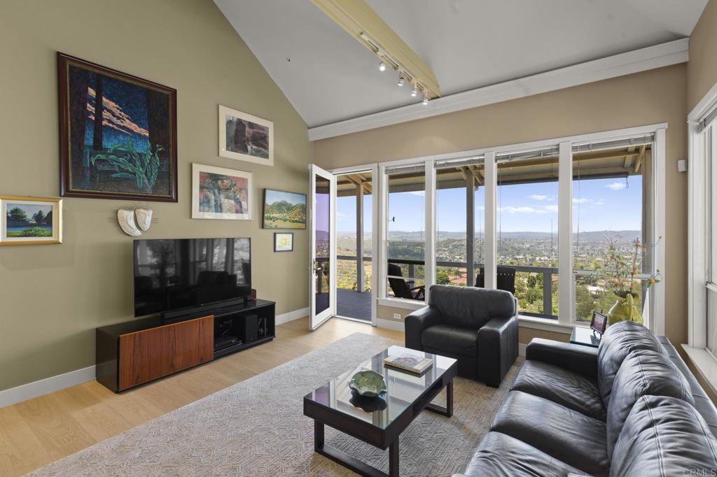 14645 High Valley Road Poway, CA 92064 - Photo 13 of 34 a living room with furniture large windows and a flat screen tv