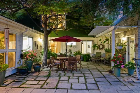 a bedroom with a bed wooden floor and window
