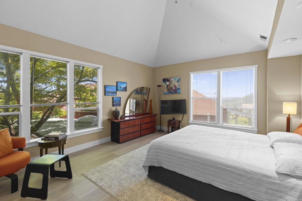 14645 High Valley Road Poway, CA 92064 - Photo 19 of 34 a bedroom with a bed and large windows