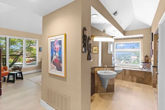 a bedroom with a bed and a dresser next to a window