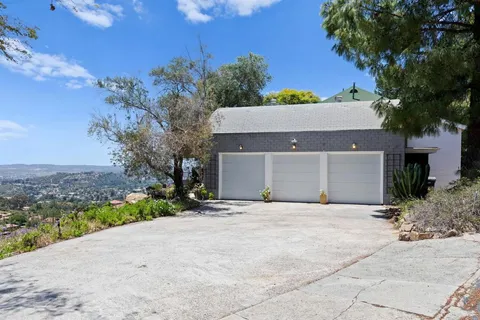 a view of a house with a yard balcony and outdoor seating