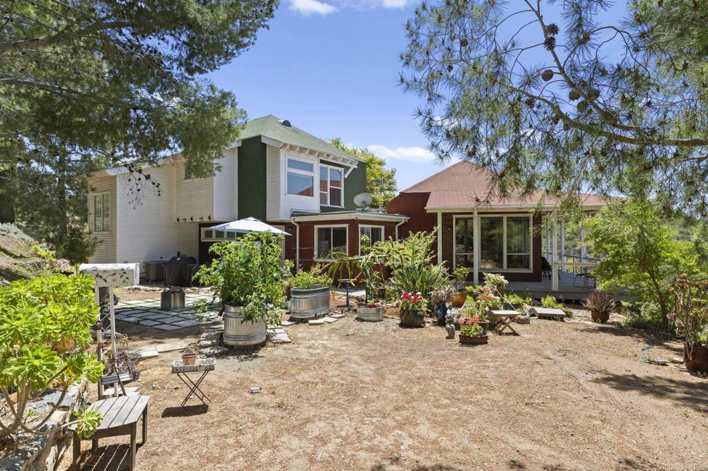 14645 High Valley Road Poway, CA 92064 - Photo 27 of 34 a view of a house with backyard sitting area and garden