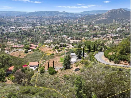 a view of a house with a yard and balcony