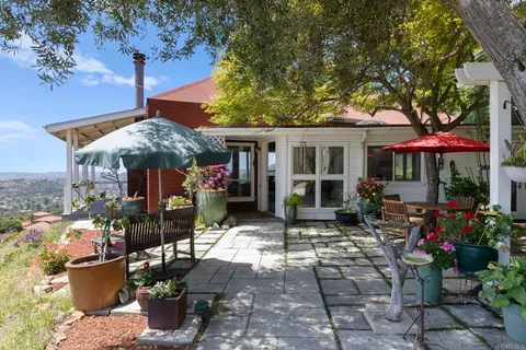 a living room with fireplace furniture and a large window