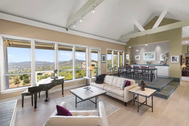 a living room with furniture fireplace and a large window