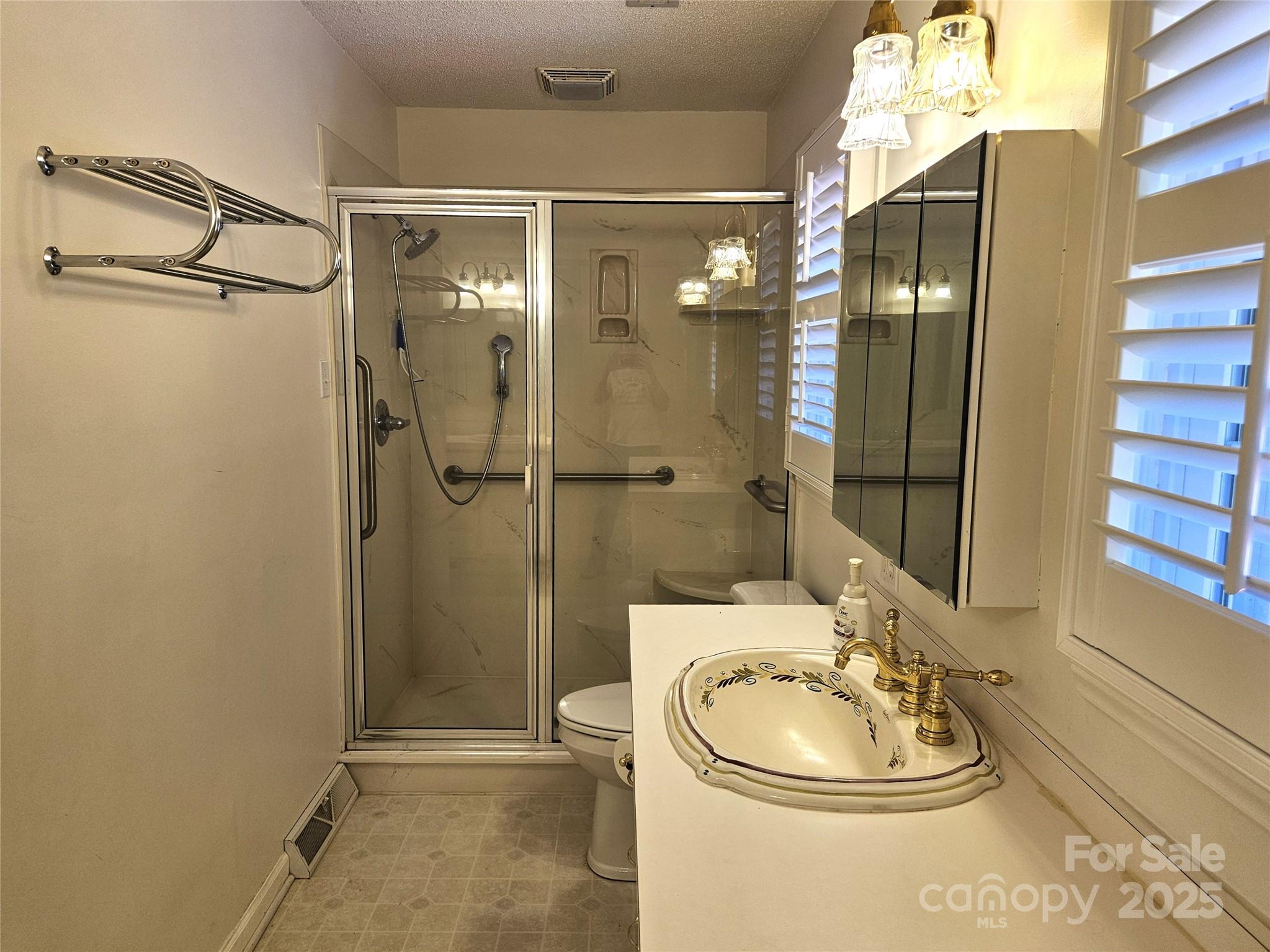 10670 Troutman Road Midland, NC 28107 - Photo 15 of 38 a bathroom with a sink toilet and shower