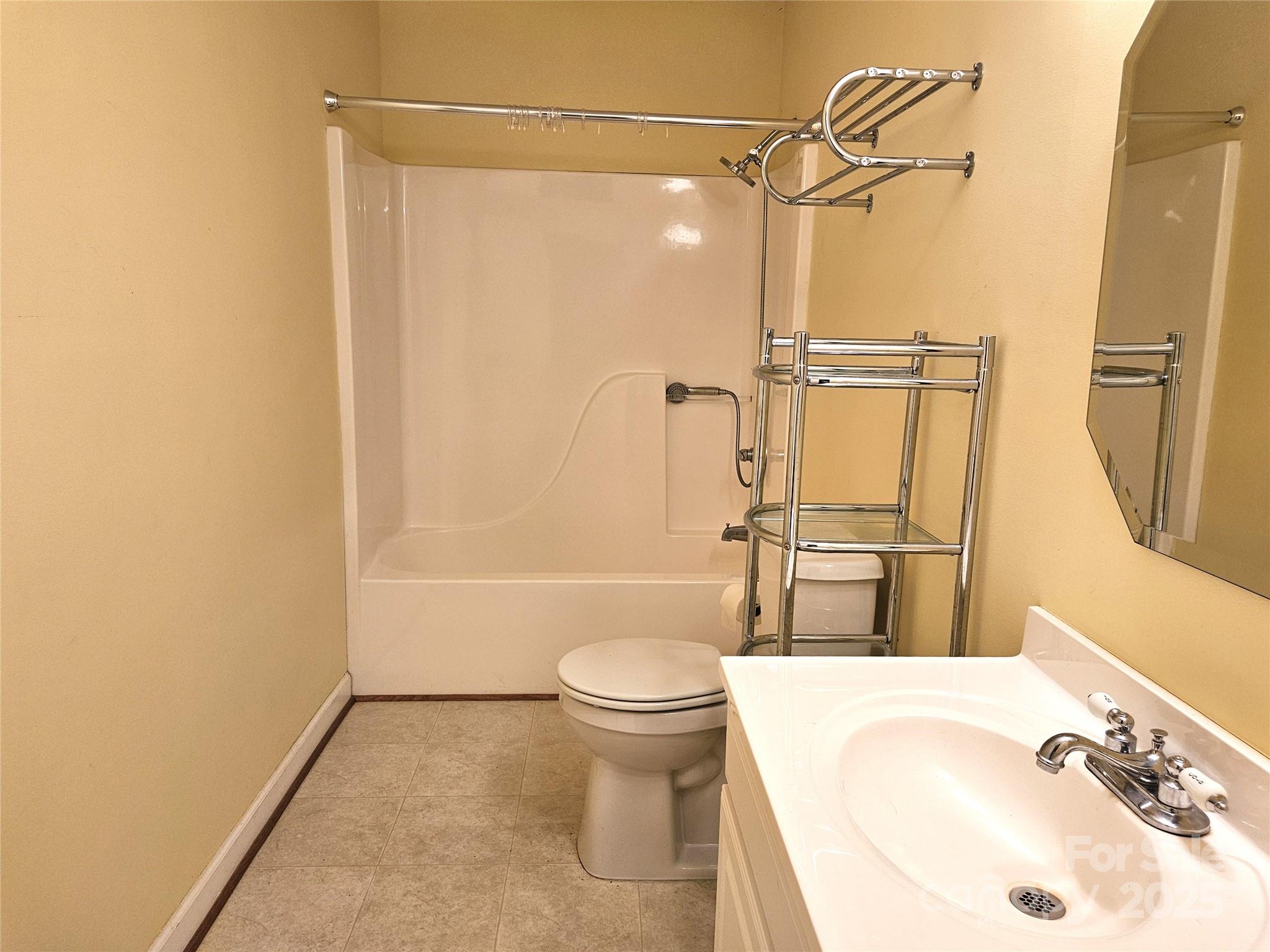 10670 Troutman Road Midland, NC 28107 - Photo 21 of 38 a bathroom with a sink toilet and shower