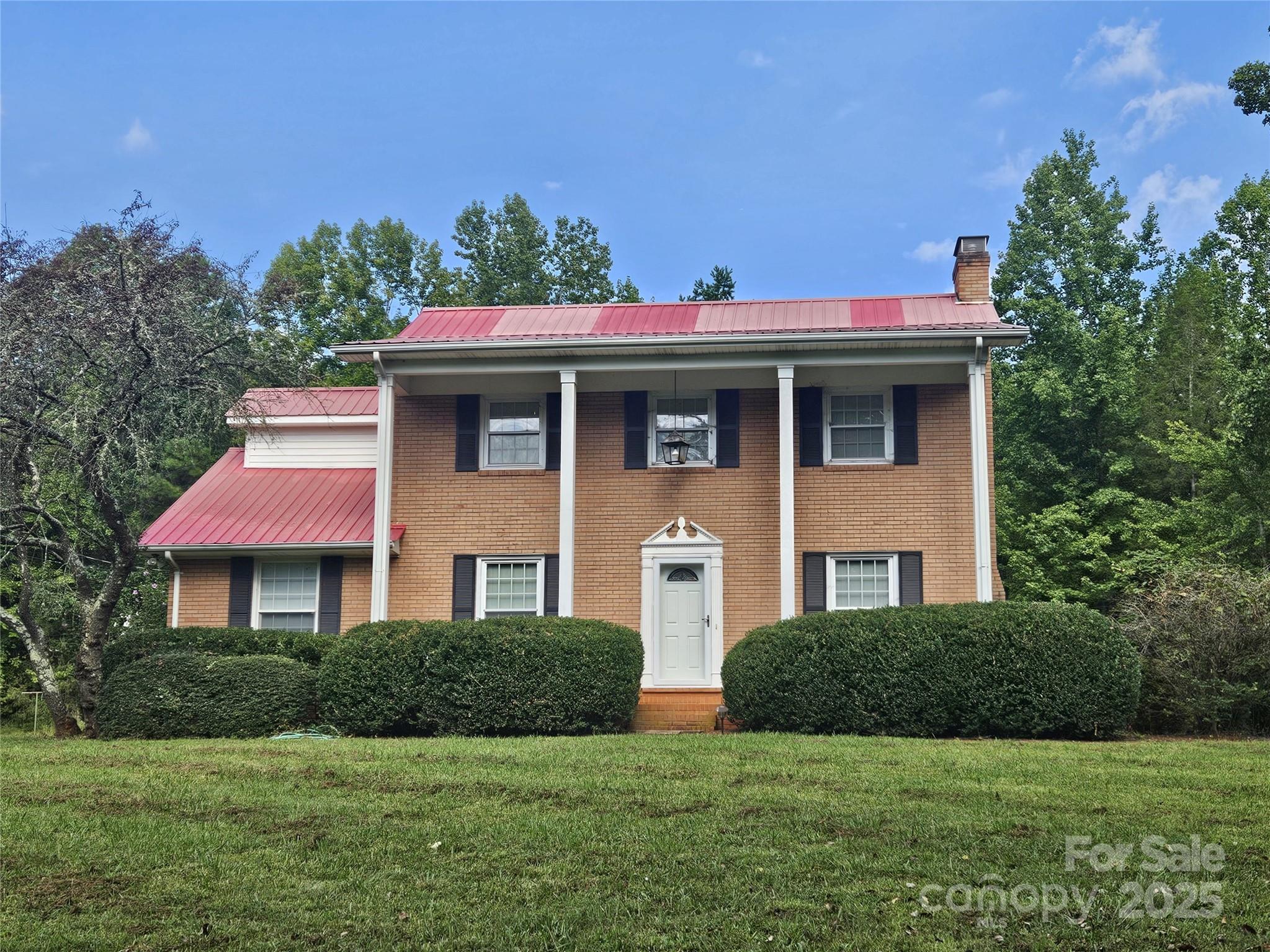 10670 Troutman Road Midland, NC 28107 - Photo 3 of 38 a front view of a house with a yard