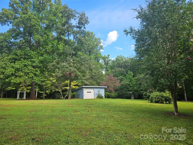 a view of a big yard with a trees
