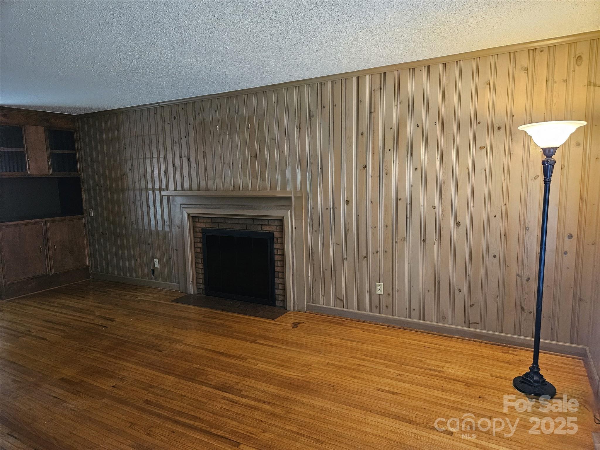 10670 Troutman Road Midland, NC 28107 - Photo 5 of 38 a view of a livingroom with wooden floor and a fireplace