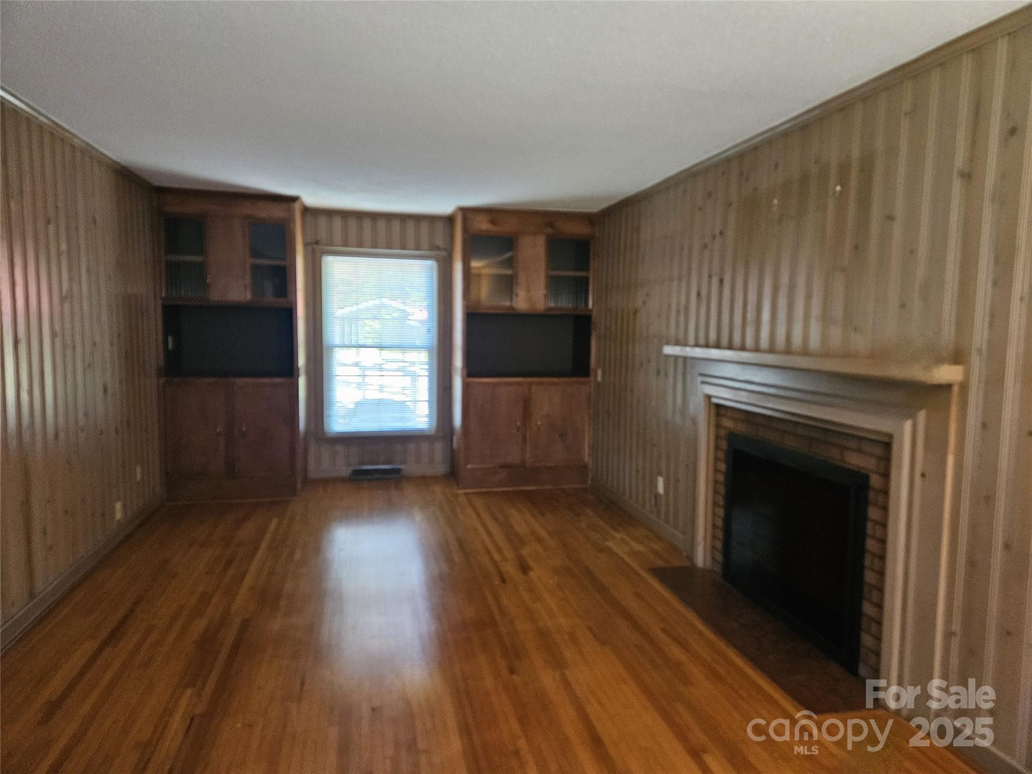 10670 Troutman Road Midland, NC 28107 - Photo 7 of 38 a view of a livingroom with wooden floor and a fireplace