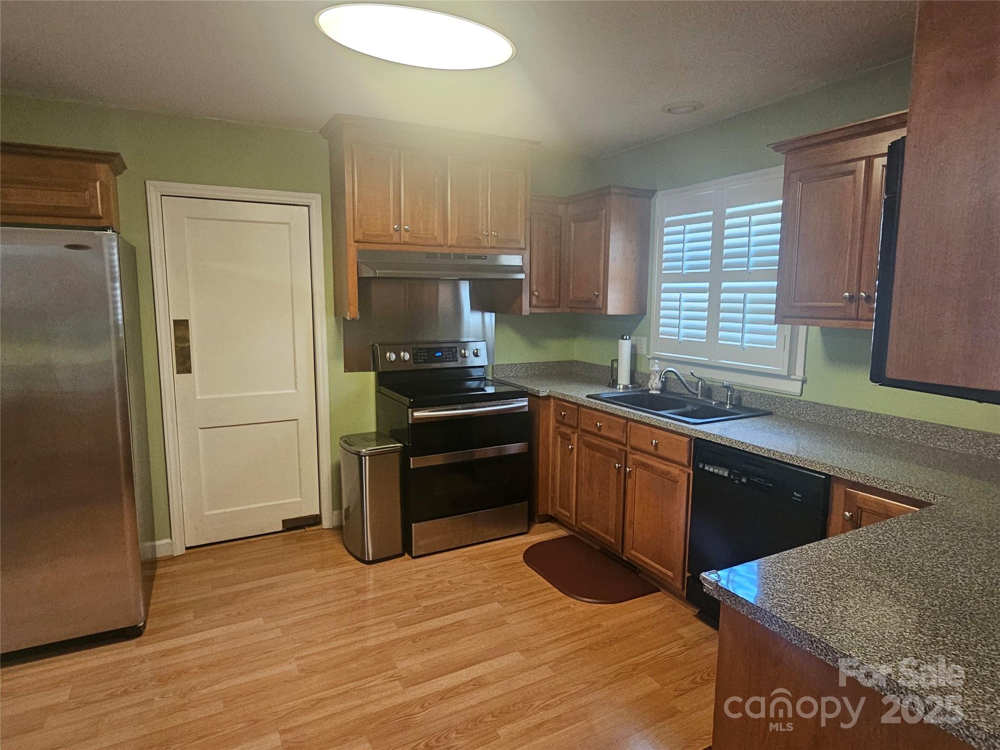 10670 Troutman Road Midland, NC 28107 - Photo 9 of 38 a kitchen with a refrigerator stove and sink