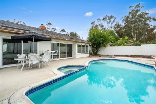 a swimming pool with outdoor seating and yard