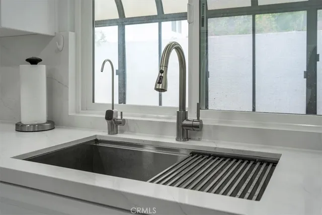 a kitchen with a sink and a large window