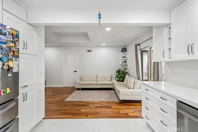 a living room with kitchen island granite countertop furniture and a fireplace