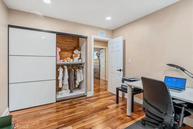a workspace with wooden floor and a cabinet