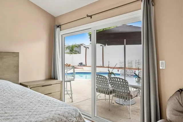 a bedroom with a bed and a refrigerator