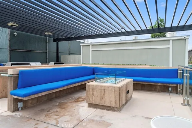 a view of a dining room with furniture a chandelier and large windows