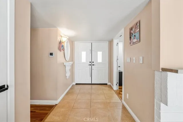 a view of a hallway with wooden floor and closet