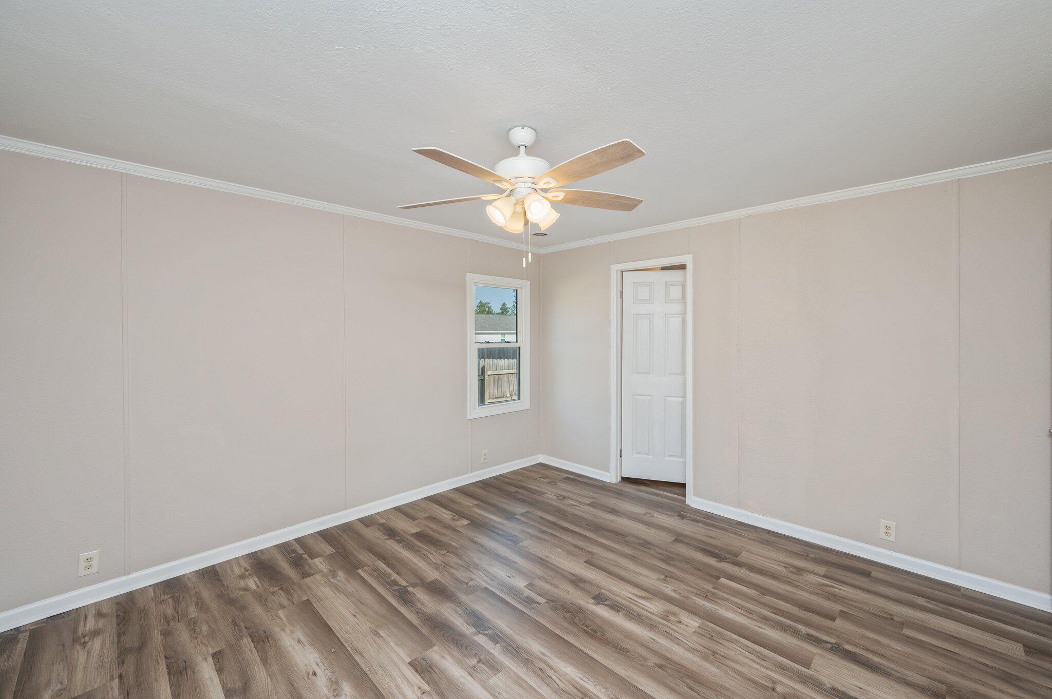 4625 Canary Way Crestview, FL 32539 - Photo 15 of 35 wooden floor in an empty room with a window