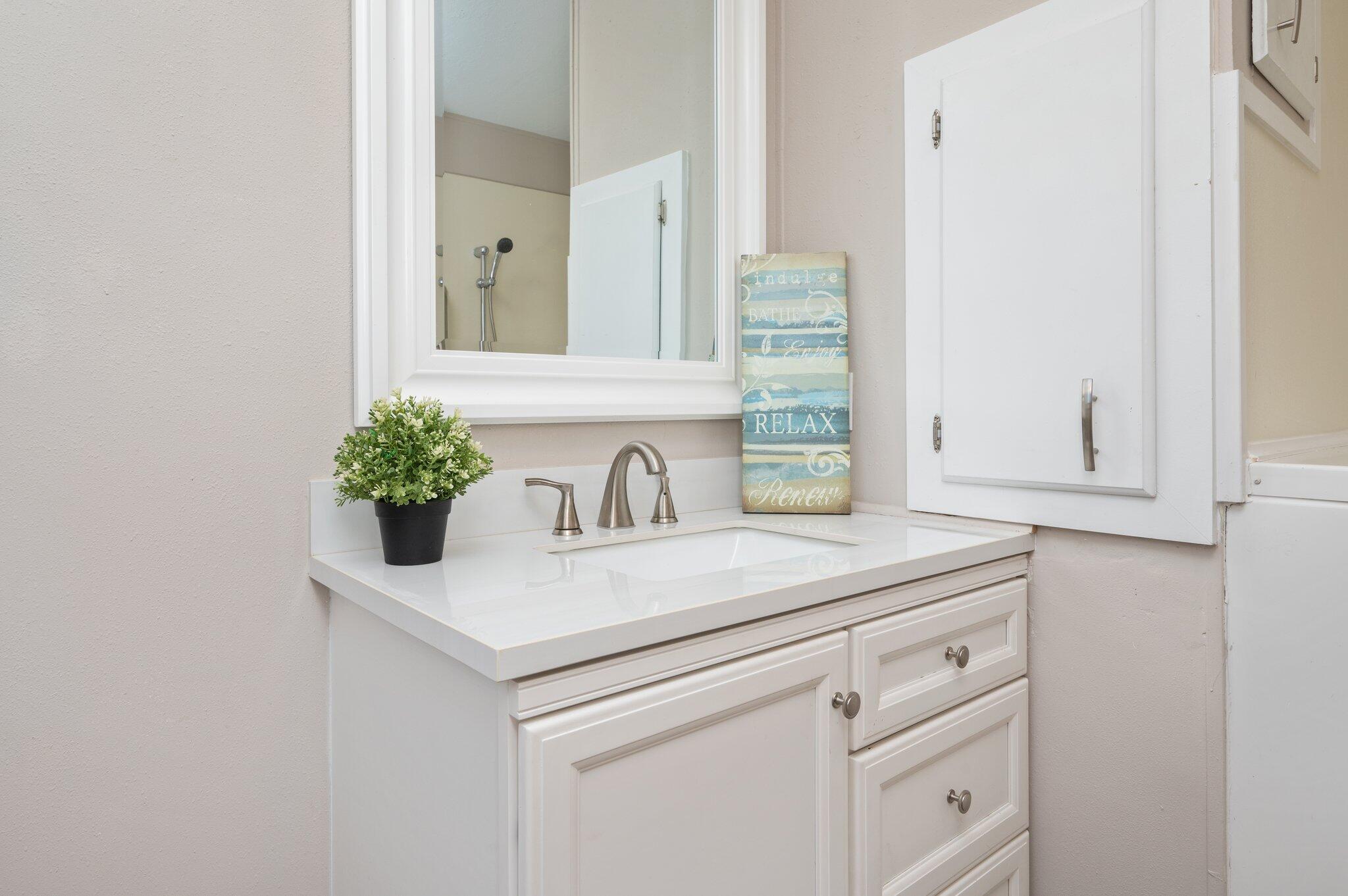 4625 Canary Way Crestview, FL 32539 - Photo 17 of 35 a bathroom with a sink and a mirror