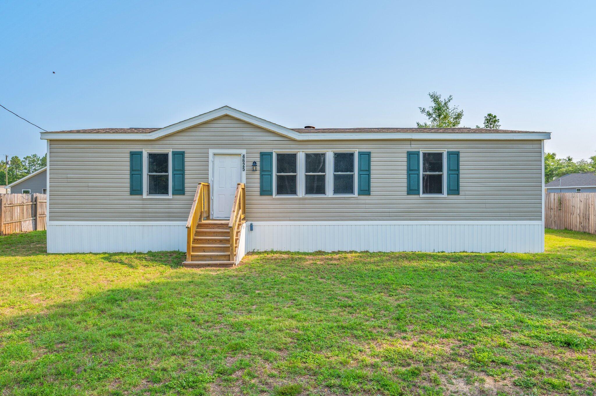 4625 Canary Way Crestview, FL 32539 - Photo 2 of 35 a front view of a house with a yard