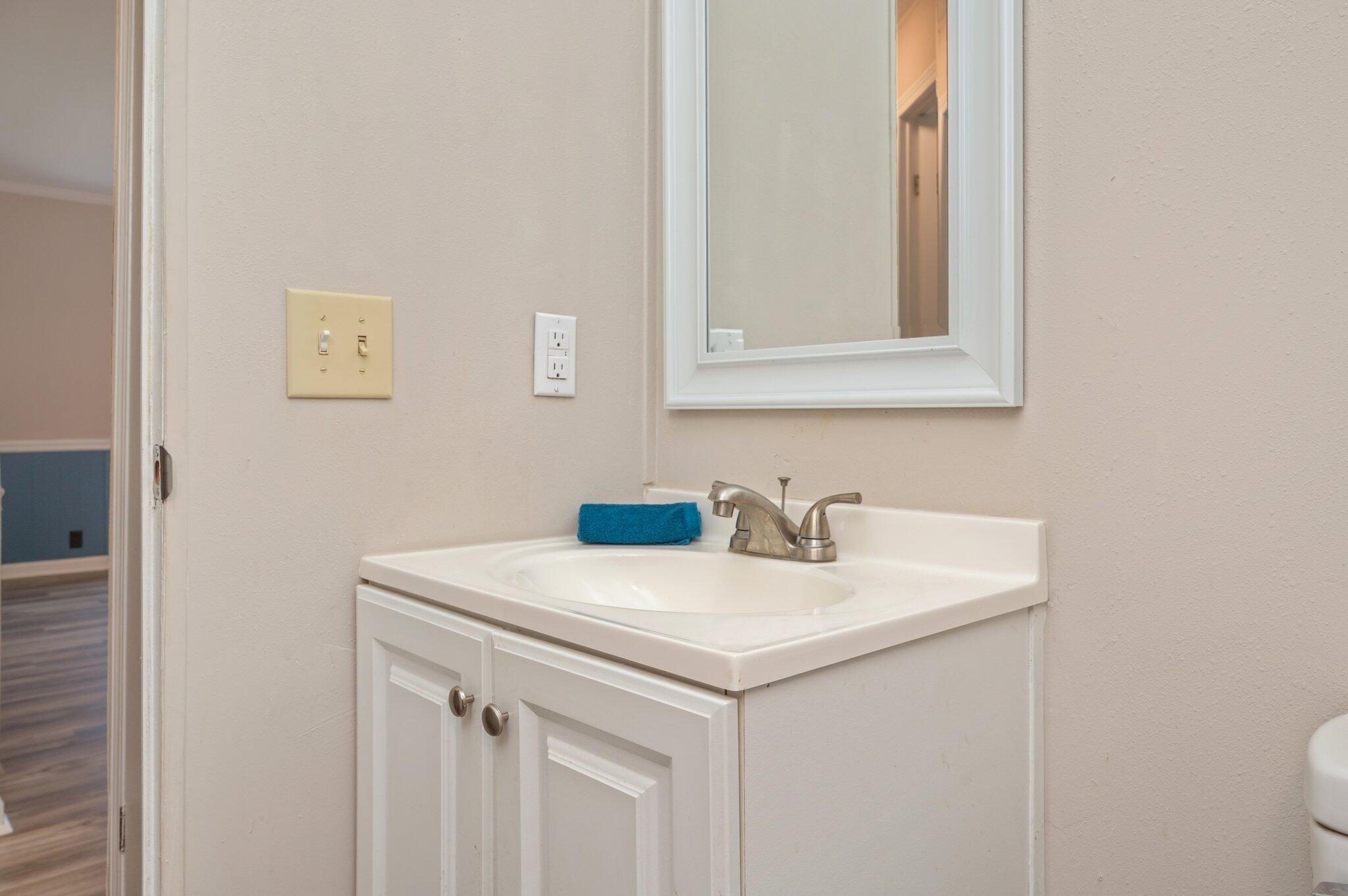 4625 Canary Way Crestview, FL 32539 - Photo 24 of 35 a bathroom with a sink and a mirror