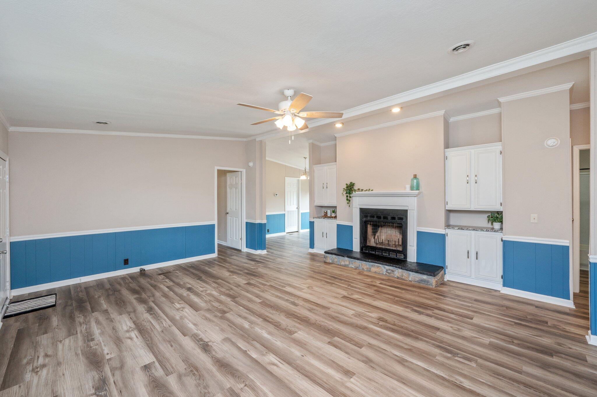 4625 Canary Way Crestview, FL 32539 - Photo 6 of 35 a view of an empty room with wooden floor fireplace and a window