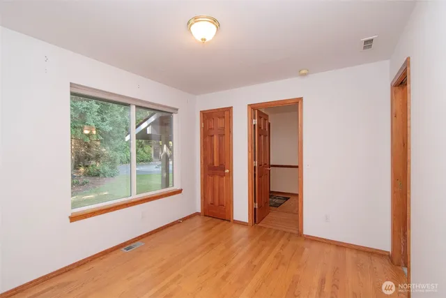 a view of a house with backyard and trees