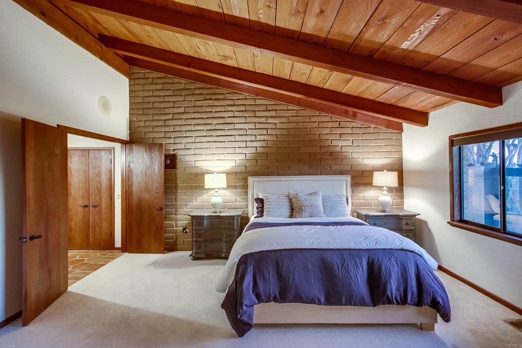 1256 Rancho Encinitas Drive Encinitas, CA 92024 - Photo 11 of 28 a bed sitting in a spacious bedroom next to a window