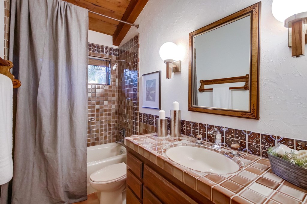 1256 Rancho Encinitas Drive Encinitas, CA 92024 - Photo 15 of 28 a bathroom with a granite countertop sink toilet and shower