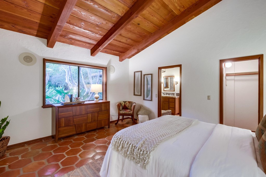 1256 Rancho Encinitas Drive Encinitas, CA 92024 - Photo 16 of 28 a bedroom with a large bed and a window