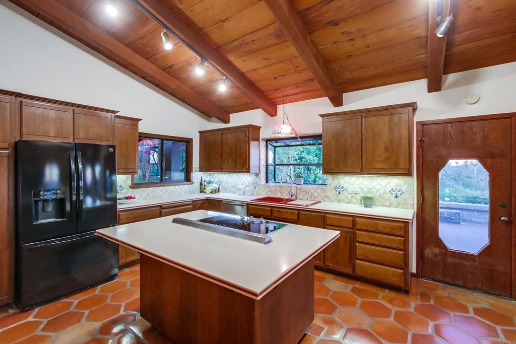 1256 Rancho Encinitas Drive Encinitas, CA 92024 - Photo 6 of 28 a kitchen with stainless steel appliances granite countertop a sink a stove and a refrigerator