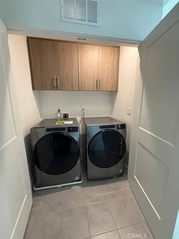 a utility room with sink dryer and washer