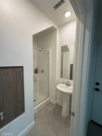 a bathroom with a sink mirror toilet and shower