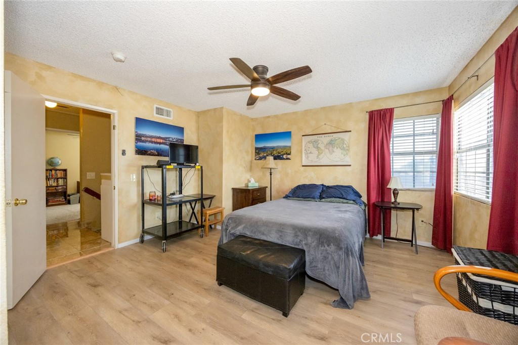 1907 Pepper Tree Lane East Colton, CA 92324 - Photo 19 of 33 a bedroom with a bed and wooden floor