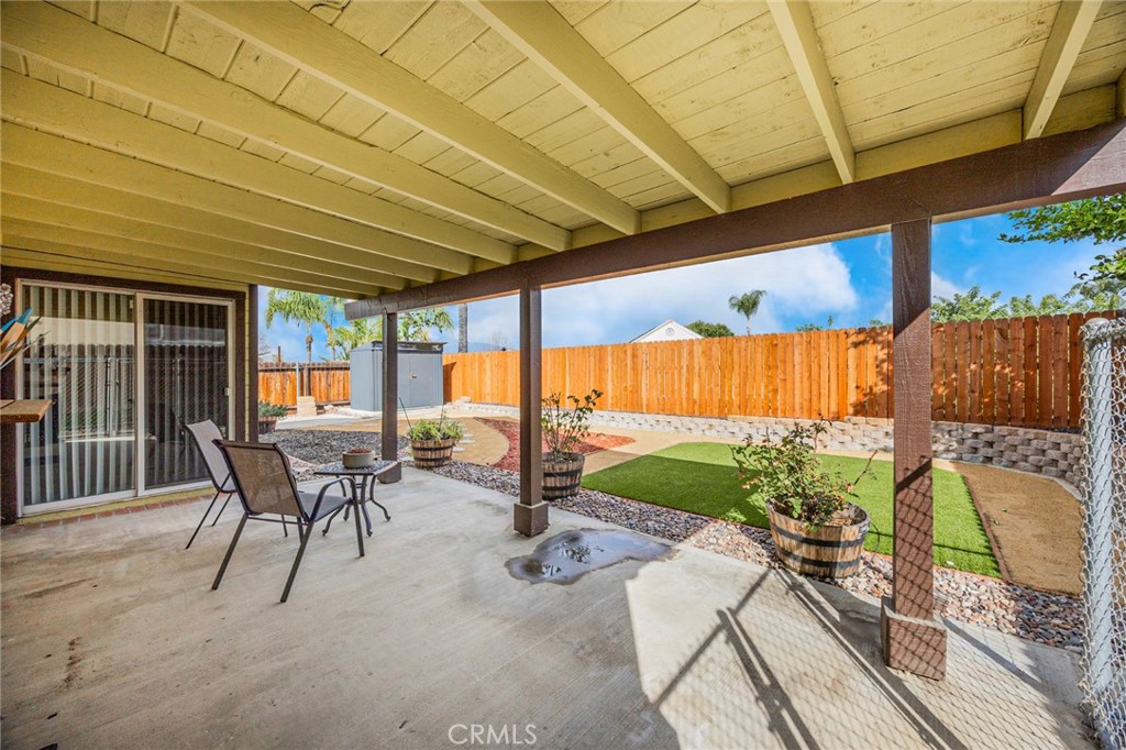 1907 Pepper Tree Lane East Colton, CA 92324 - Photo 30 of 33 a view of a patio with table and chairs potted plants with wooden floor