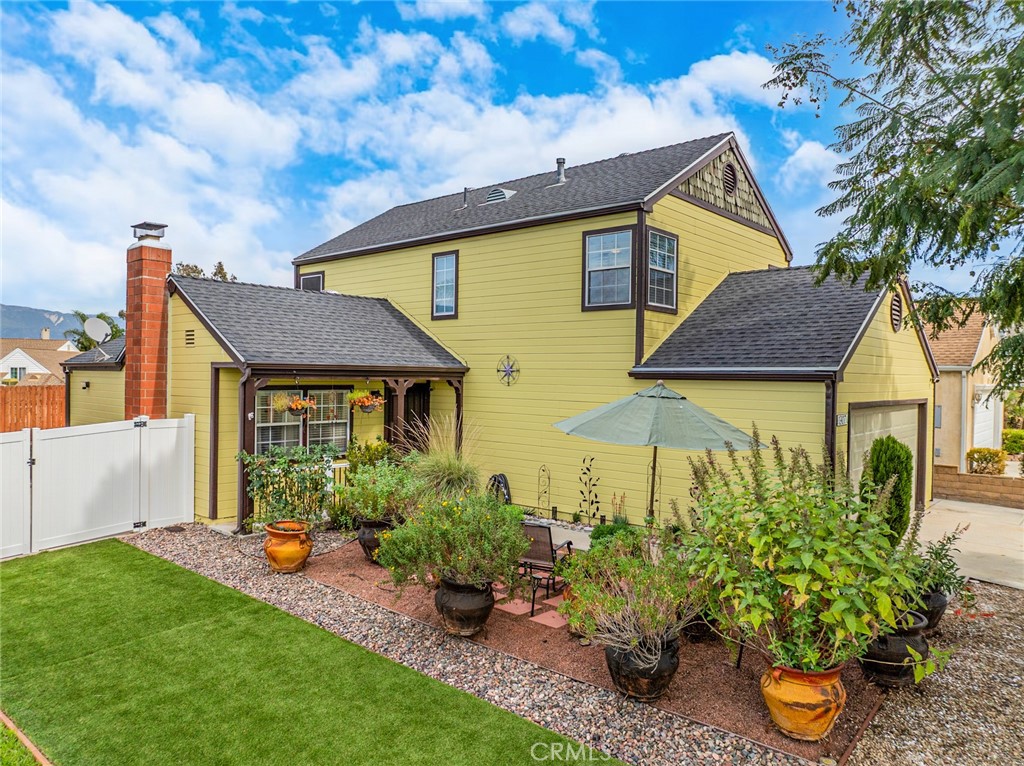 1907 Pepper Tree Lane East Colton, CA 92324 - Photo 3 of 33 a front view of a house with a yard and potted plants
