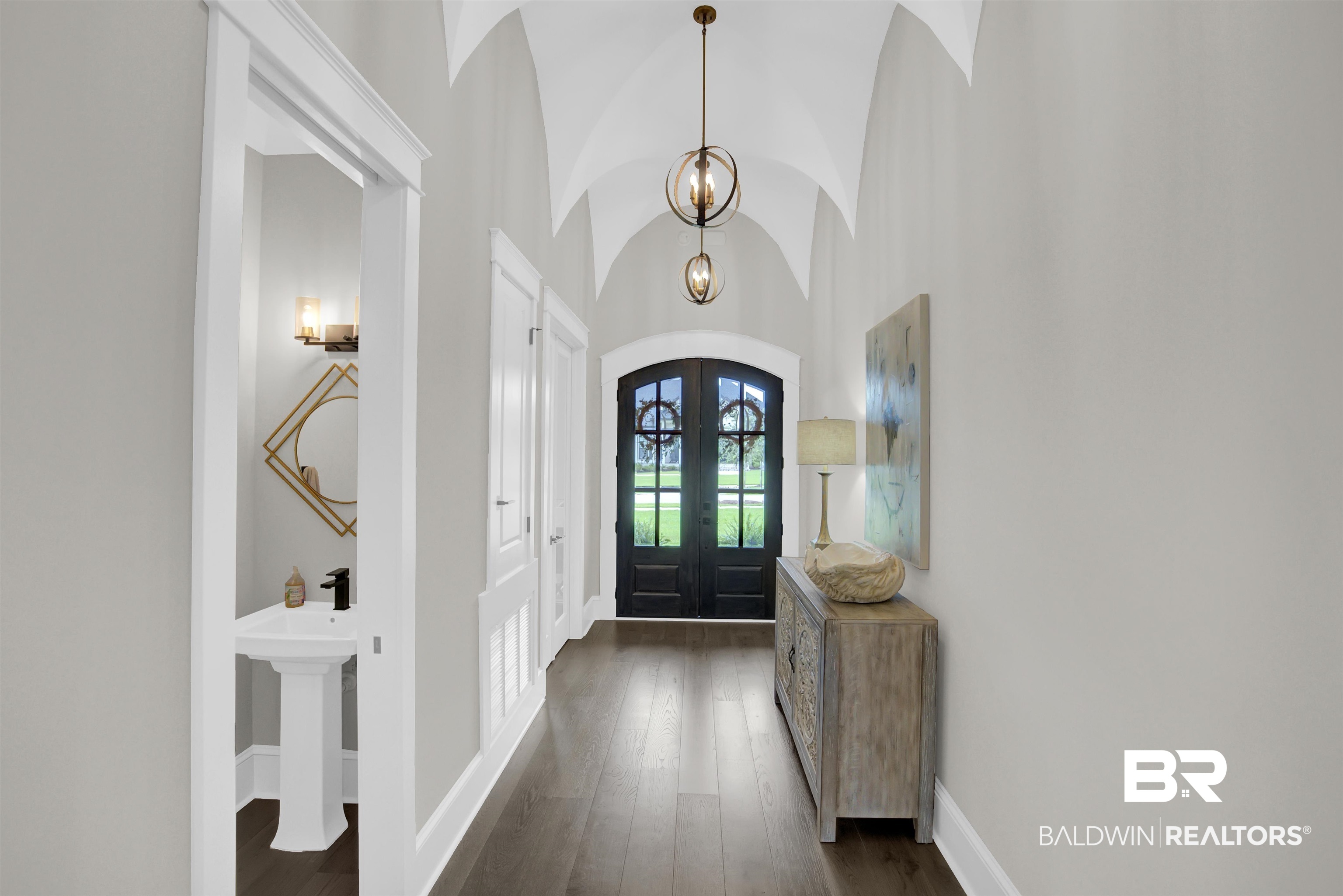 10940 Atrium Avenue Fairhope, AL 36532 - Photo 5 of 43 Entryway with sink, french doors, dark wood-type flooring, high vaulted ceiling, and a notable chandelier