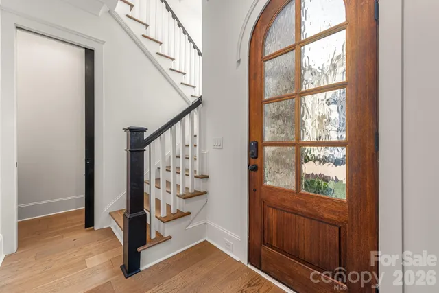 a view of an entryway with wooden floor and door