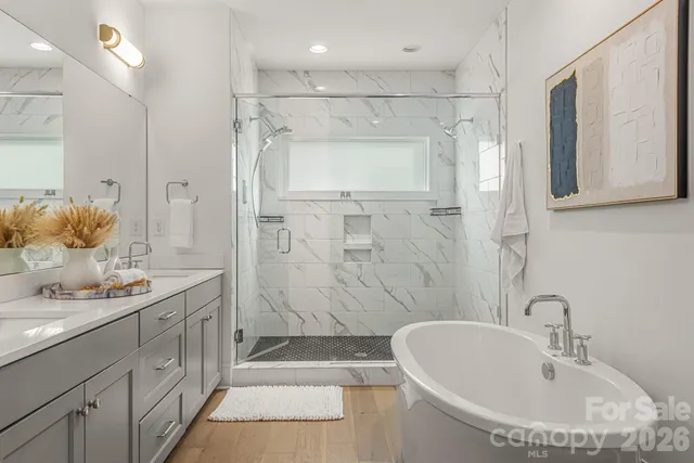 a bathroom with a double vanity sink mirror double and shower