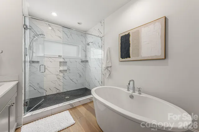 a bathroom with a bathtub and a shower