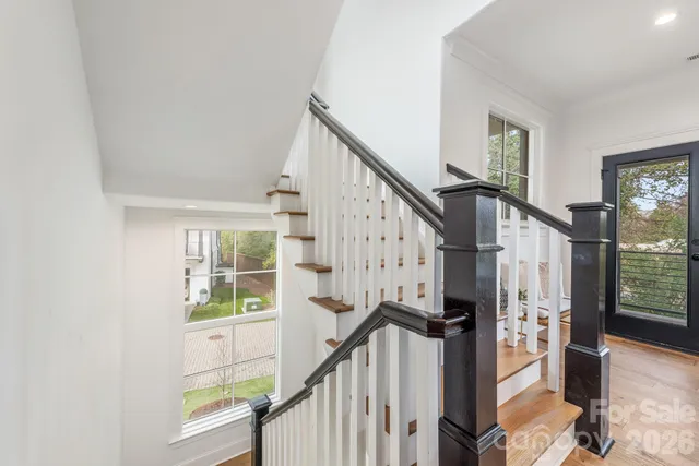 a view of entryway with wooden floor and windows