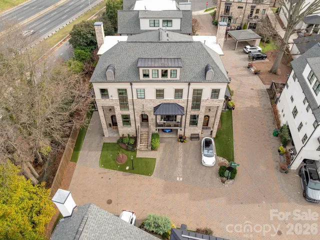 an aerial view of a house with large trees