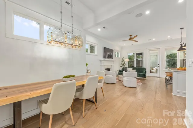 a view of a dining room with furniture wooden floor and chandelier