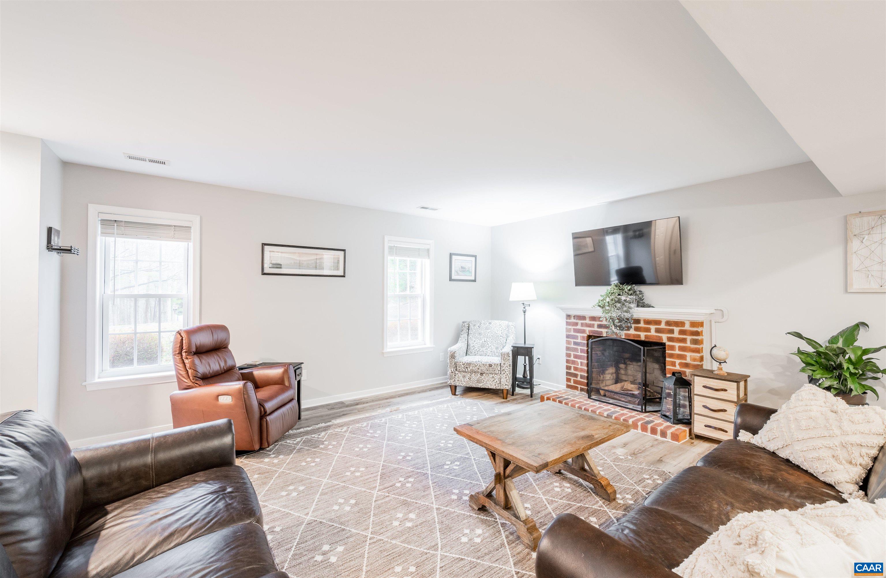 308 Starcrest Road Charlottesville, VA 22902 - Photo 12 of 35 a living room with furniture flat screen tv and a fireplace