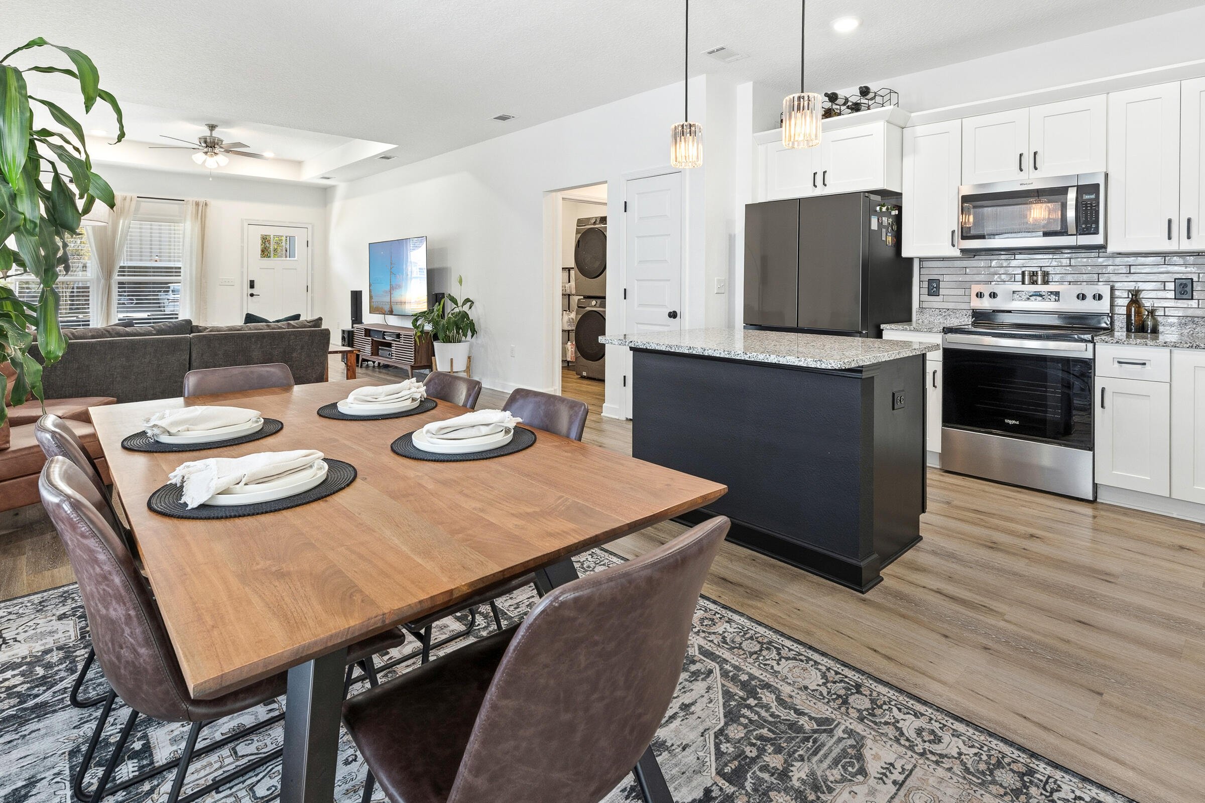 65 Marsh Landing North Freeport, FL 32439 - Photo 12 of 35 a kitchen with stainless steel appliances granite countertop a kitchen island a stove a table and chairs