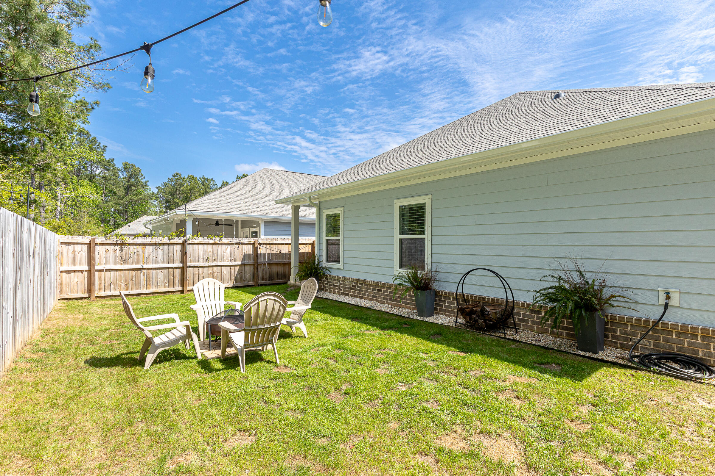 65 Marsh Landing North Freeport, FL 32439 - Photo 29 of 35 a view of a patio with table and chairs and potted plants with wooden fence